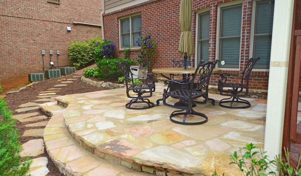 Outdoor Makeover: Renovated stone patio with outdoor furniture