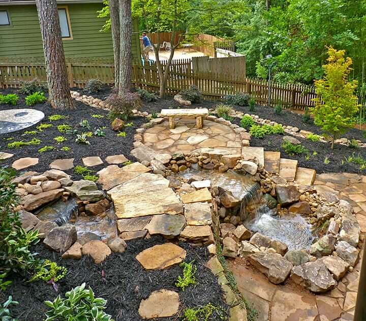 stone hardscaping with garden fountain water fall feature